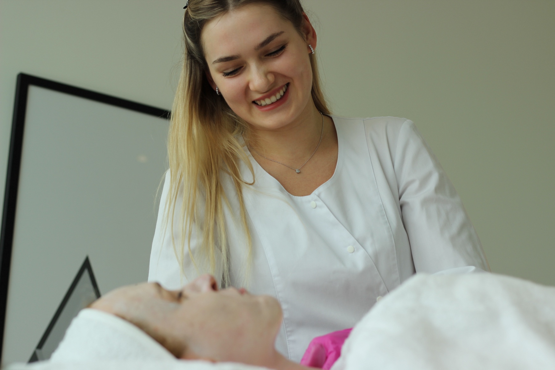Dr. Alona Mazurenko during a facial treatment in Limassol